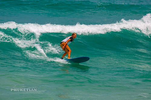 Girl in a bikini on a surf on a high wave. Nai Harn Beach, Phuket, Thailand                   XOKA5753bs ©  Phuket@photographer.net