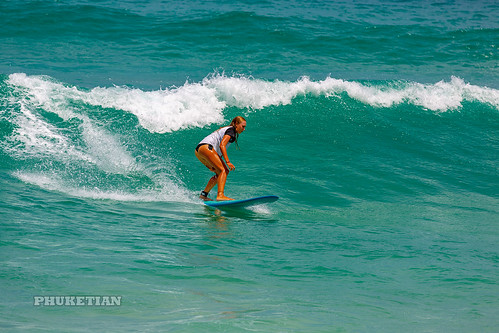 Girl in a bikini on a surf on a high wave. Nai Harn Beach, Phuket, Thailand                 XOKA5752bs ©  Phuket@photographer.net