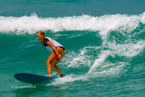 Girl in a bikini on a surf on a high wave. Nai Harn Beach, Phuket, Thailand                   XOKA5753b3s ©  Phuket@photographer.net