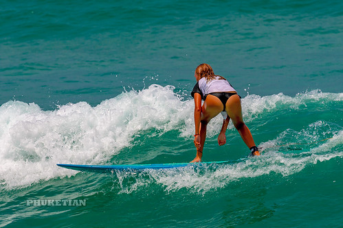 Girl in a bikini on a surf on a high wave. Nai Harn Beach, Phuket, Thailand            XOKA5756b3s ©  Phuket@photographer.net