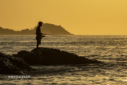 Fisherman on the rocks at sunset. Patong (Kalim) beach, Phuket, Thailand    XOKA9449bs ©  Phuket@photographer.net