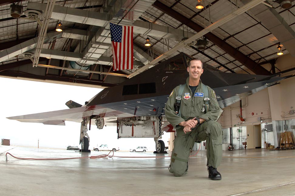 : Retired Col Jack Forsythe in front of the flag Lockheed F-117A Nighthawk at Tonopah AFB, Nevada, after the last mission April 22, 2008.