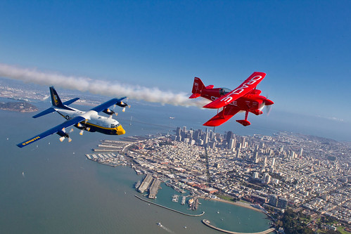 In advance of Fleet Week performances, the U.S. Navy 'Blue Angels' and 'Team Oracle' aerobatics pilot Sean D. Tucker fly over the San Francisco Bay during a photo flight. ©  Robert Sullivan