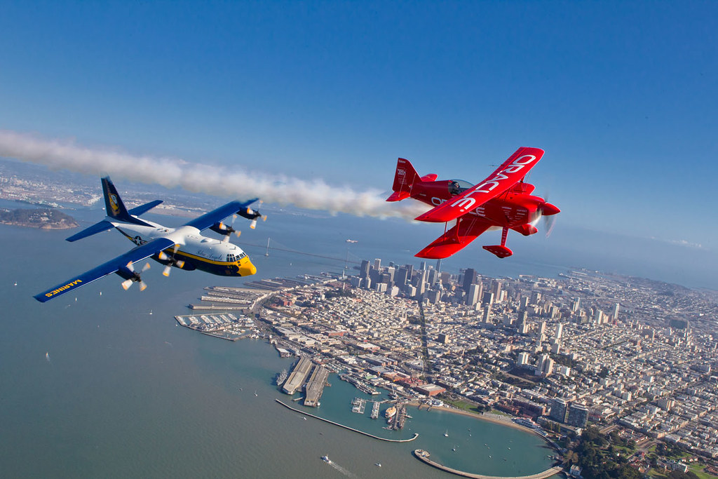 : In advance of Fleet Week performances, the U.S. Navy 'Blue Angels' and 'Team Oracle' aerobatics pilot Sean D. Tucker fly over the San Francisco Bay during a photo flight.