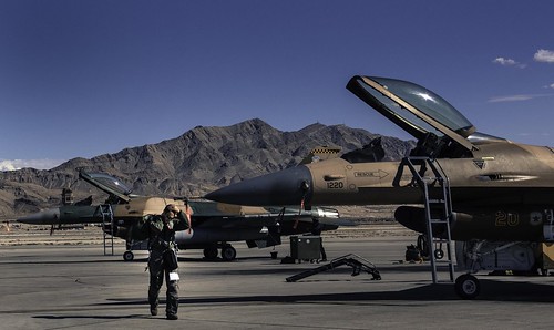 A 64th Aggressor pilot walks from a General Dynamics (its aviation unit now part of Lockheed Martin) F-16 