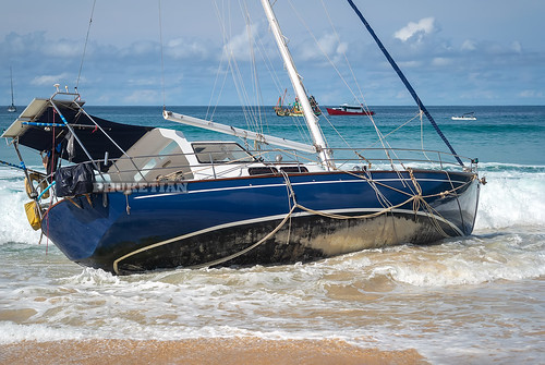 Disaster at sea. The wreck of a sailing yacht. Yacht was dropped from the anchor and thrown to the beach. Waves break the hull and fill it with water. Nai Harn Beach, Phuket, Thailand 25 October 2019 ©  Phuket@photographer.net