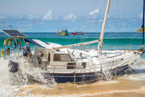 Disaster at sea. The wreck of a sailing yacht. Yacht was dropped from the anchor and thrown to the beach. Waves break the hull and fill it with water. Nai Harn Beach, Phuket, Thailand 25 October 2019 ©  Phuket@photographer.net