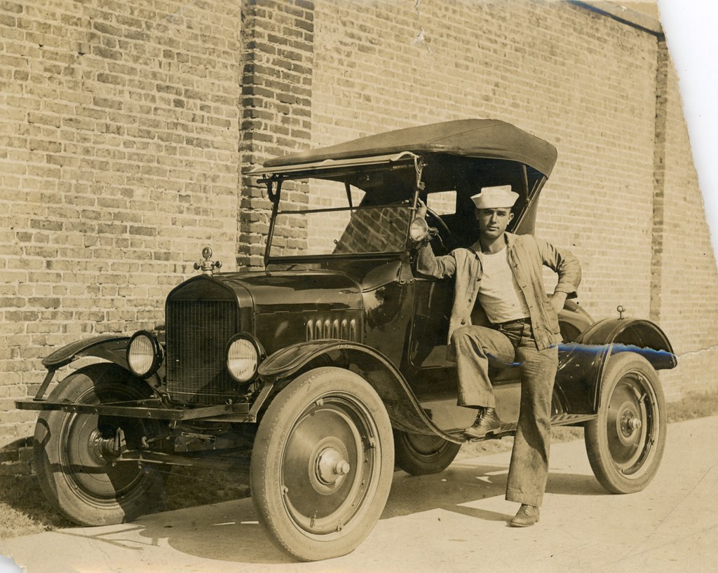 : Luther W. Coleman standing with his Chevrolet in St. Petersburg