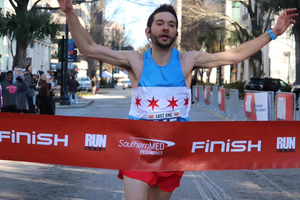 Crossing the finish line in first place at the Run Hard Columbia Half Marathon