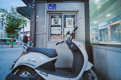 scooter next to flower shop ©  Tony