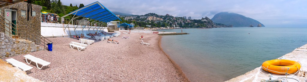 : Beach on the Black Sea coast with sunbathing tourists (Seascape)