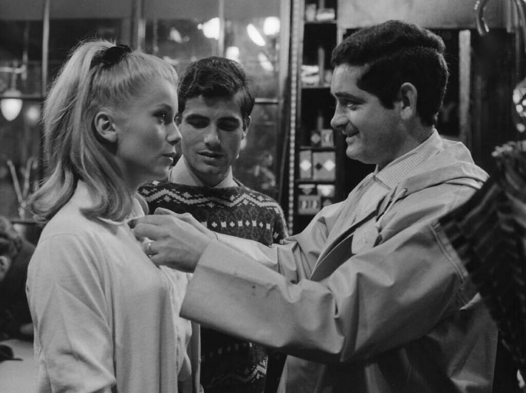 : Catherine Deneuve and Jacques Demy on the set of The Umbrellas of Cherbourg, 1964