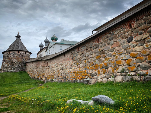 A stone wall of Solovetski Monastery with church domes and defensive tower, Solovki, Russia, June 2019 ©  sergei.gussev