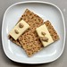 Two Rye Crackers with Cheddar Cheese and Stone Ground Mustard