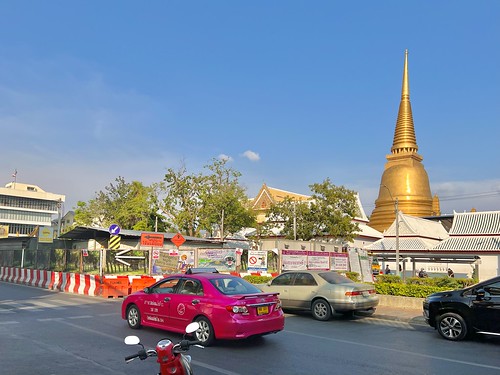 A Buddhist temple pagoda and motor vehicles ©  Sharon Hahn Darlin