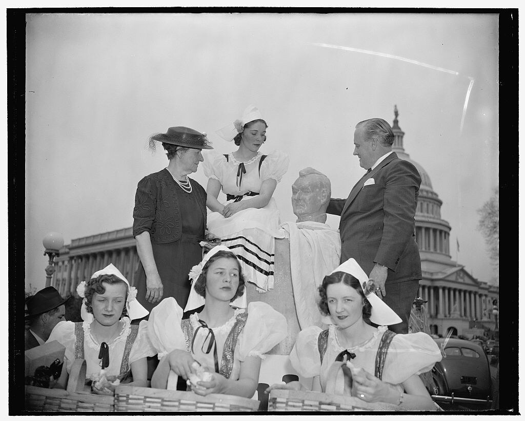: Mrs. Garner receives cheese bust of husband. Washington, D.C., April 25. Wisconsin, at present celebrating its Diamond Jubilee Cheese Week, sent to Washington a 2,200 lb. cheese and a bust of the Vice President done in cheddar cheese. Here, Wisconsin's Se