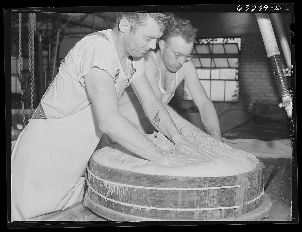 : Pressing the curd into form. Swiss cheese factory. Madison, Wisconsin (LOC)