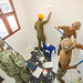 U.S. Navy Seabees and a Royal Australian Army engineer paint the walls of the maternity ward at Vera Cruz Health Clinic during a renovation project.