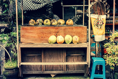 Fresh and young coconuts on the street market. Bali island, Indonesia.