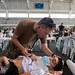 U.S. Navy Lt. Cmdr. Joseph Harmon, a pediatric neurologist assigned to the hospital ship USNS Comfort (T-AH 20), listens to the breathing of a 19-year-old man suffering from a traumatic brain injury at a temporary medical treatment site in Santa Marta, Co