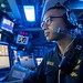 A Sailor stands watch in the command control center aboard USS John P. Murtha (LPD 26) as the ship arrives in Subic Bay, Philippines.