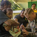 A Sailor gives a child a vaccine at the Angaur Community Center, Sept. 27, 2019.