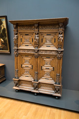 Antique cabinet with carved figures