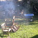 Starting the Sur smoke fire, chairs, tables to be set up for the feast, firepit, chairs, grass, yard, North Bend, Washington, USA