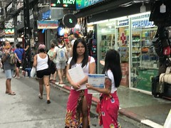 Sour faced Katoyes (ladyboys) soliciting customers on Soi Bangla