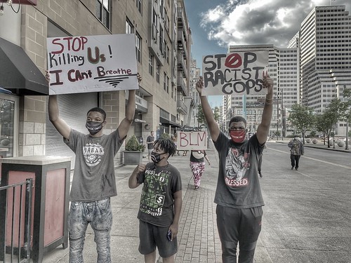 George Floyd protesters; signs say 'Stop Racist Cops' and 'Stop Killing Us! I Can't Breathe'