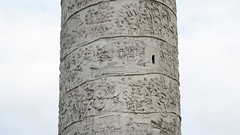 Column of Trajan, Trajan oversees fort construction, wounded Romans cared for (scenes 39-40); Dacians petition Trajan, boats are loaded (scenes 46-47); Trajan address with standards, Romans march up hill, clear wooded area (scenes 54-56)