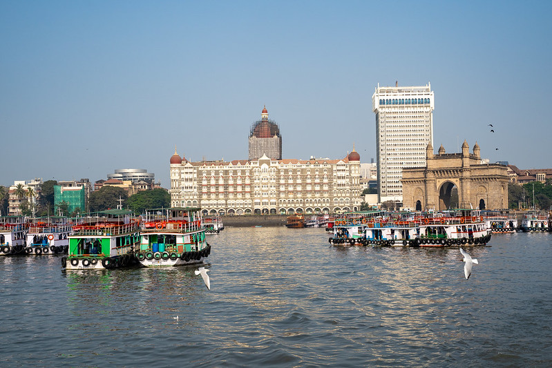 Mumbai, India - February 29, 2020: Ferry harbor of Mumbai with a view from the water of ferry boats, the Taj hotel and Gateway of India<br/>© <a href="https://flickr.com/people/39908901@N06" target="_blank" rel="nofollow">39908901@N06</a> (<a href="https://flickr.com/photo.gne?id=50111824883" target="_blank" rel="nofollow">Flickr</a>)