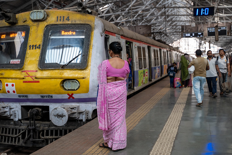 Mumbai, India - February 29, 2020: Indian woman wearing a sari waits for her train at Chatrapati Shivaji Terminus earlier known as Victoria Terminus in Mumbai, India<br/>© <a href="https://flickr.com/people/39908901@N06" target="_blank" rel="nofollow">39908901@N06</a> (<a href="https://flickr.com/photo.gne?id=50234853382" target="_blank" rel="nofollow">Flickr</a>)