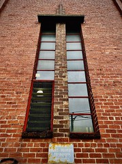 257/366 Here is a profile of magnificent 1930s period window on the side of the Brunswick tram depot. The brickwork includes Art Deco flourish and detail. Note the MMTB sign warning against trespassing