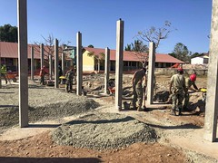 Seabees assigned to U.S. Naval Mobile Construction Battalion (NMCB) 3 Detail Timor-Leste work with Forsa Defesa Timor-Leste service members to backfill and compact grade beams for the construction of the Vila Nova three-room school house.