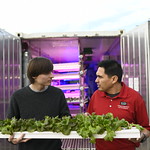 2020 graduate Mark Watson and horticultural scientist Ricardo Hernandez at a shipping container for vertical farming