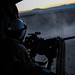 Naval Aircrewman (Helicopter) 3rd Class Copper McCambridge, from Murrieta, Calif., assigned to the “Black Knights” of Helicopter Sea Combat Squadron (HSC) 4, fires a .50-caliber machine gun during an initial aerial gunnery training qualification.