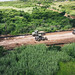 Naval Mobile Construction Battalion 3 Seabees, deployed as the Seabee expeditionary construction and engineering capability of Task Force 75, operate heavy equipment to excavate subbase and basecourse in support of Marpo Heights Road G construction in Tin