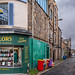 Street with tailor shop in Edinburgh's Stockbridge area, Scotland