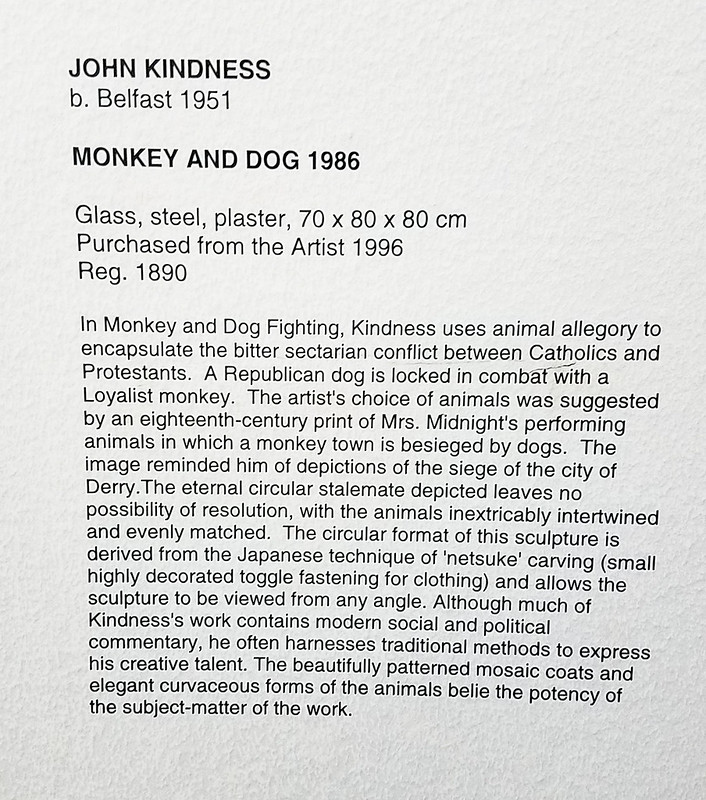Museum Placard for "Monkey and Dog 1986" by John Kindness<br/>© <a href="https://flickr.com/people/144075308@N06" target="_blank" rel="nofollow">144075308@N06</a> (<a href="https://flickr.com/photo.gne?id=50620840968" target="_blank" rel="nofollow">Flickr</a>)