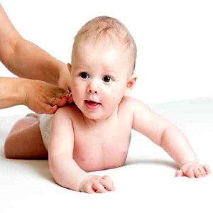 mother give baby back massage