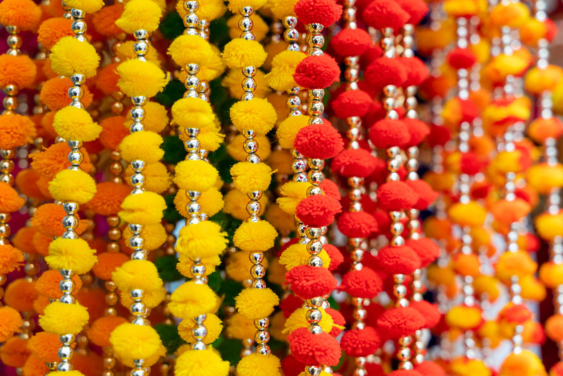 Colorful hanging Indian decorations for sale in colors of yellow, orange and red in Old Delhi market in India<br/>© <a href="https://flickr.com/people/39908901@N06" target="_blank" rel="nofollow">39908901@N06</a> (<a href="https://flickr.com/photo.gne?id=50663013761" target="_blank" rel="nofollow">Flickr</a>)
