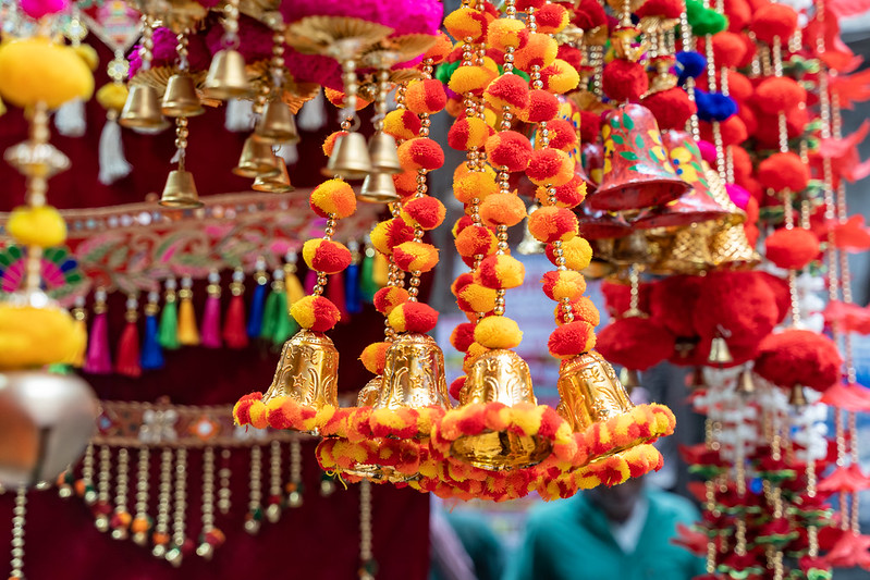 Colorful hanging Indian decorations for sale in colors of yellow, orange and red in Old Delhi market in India<br/>© <a href="https://flickr.com/people/39908901@N06" target="_blank" rel="nofollow">39908901@N06</a> (<a href="https://flickr.com/photo.gne?id=50663016691" target="_blank" rel="nofollow">Flickr</a>)
