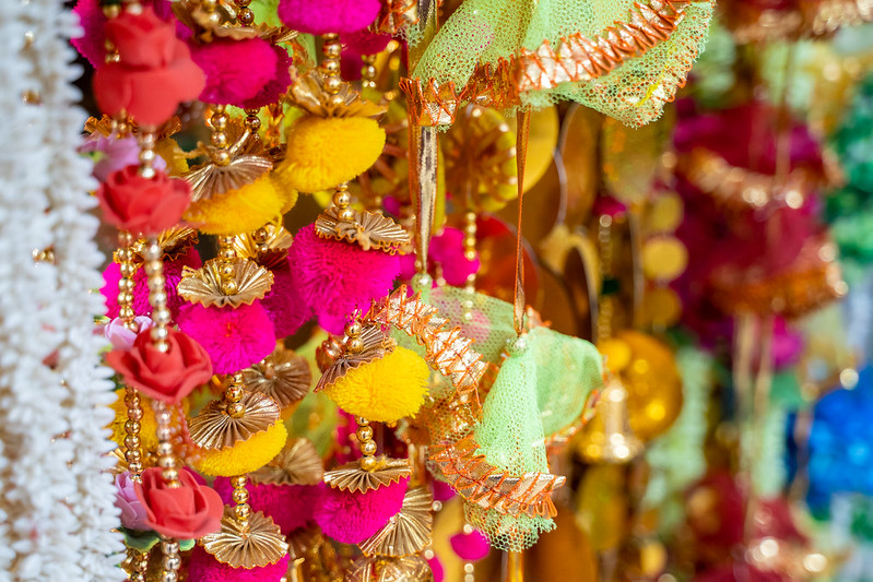 Colorful fabric decorations on display for sale in Chandi Chowk Old Delhi. These flowers, beads and bells designs are popular in weddings, festivals and events.<br/>© <a href="https://flickr.com/people/39908901@N06" target="_blank" rel="nofollow">39908901@N06</a> (<a href="https://flickr.com/photo.gne?id=50771006148" target="_blank" rel="nofollow">Flickr</a>)