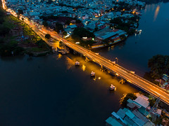 Long Exposure Drone Photo of a Small Bridge over Saigon River connecting District 7 and District 8 at Night in Ho Chi Minh City, Vietnam