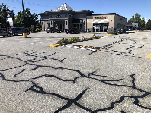 Parking lot asphalt pavement crack sealing