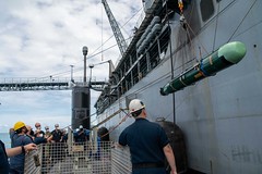 USS Hampton (SSN 767) and USS Frank Cable (AS 40) conduct a weapons handling exercise on Saipan.