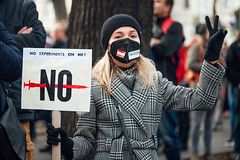 Austrian vax mandate protester holding a sign with the message "No experiments on me"