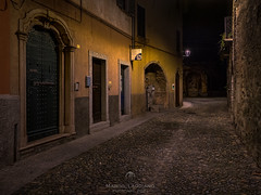 At night, through the alleys of Cannobio, Book V