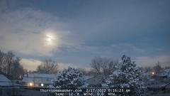 February 17, 2022 - A pretty start to the day with fresh snow and a setting moon. (ThorntonWeather.com)